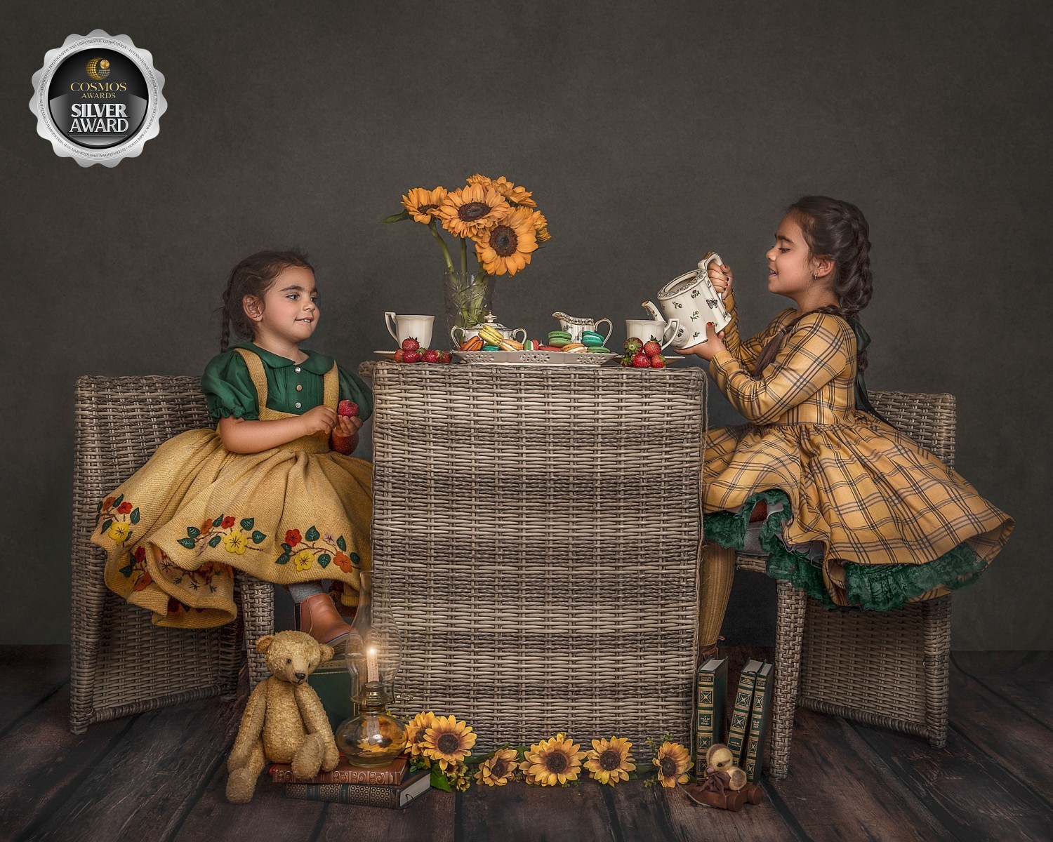 Tea party Photography session featuring two sisters , in matching yellow tones enjoying a tera party, taken by photographer Sonia Gourlie 
