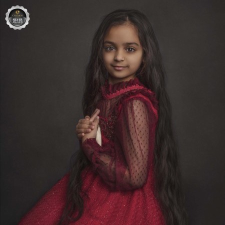 Young girl dressed in a vintage red dress, taken as part of her Milestone photography session with Sonia Gourlie Fine art Photography in Ottawa Ontario 