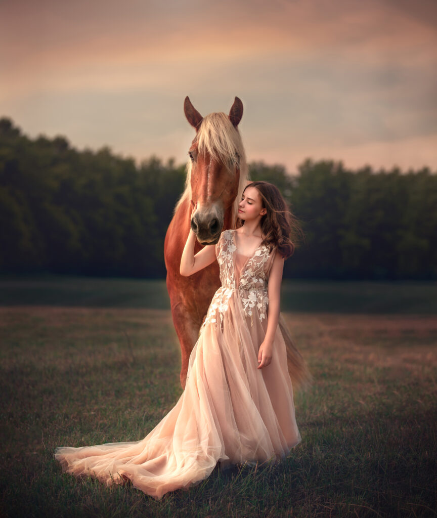 Teen girl in couture gown snuggling with a horse at golden hour: “A teen girl in a stunning couture gown snuggling with a large brown horse during golden hour outdoors in Ottawa, Ontario, captured by Sonia Gourlie Fine Art Photography. The warm, soft light of the golden hour enhances the intimate connection between the girl and the horse, making it the best photoshoot timing for capturing elegant and natural moments with your pets.”