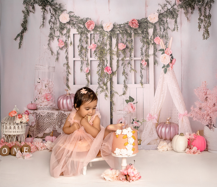 Baby enjoying first birthday cake smash with floral pumpkin  Ottawa backdrop