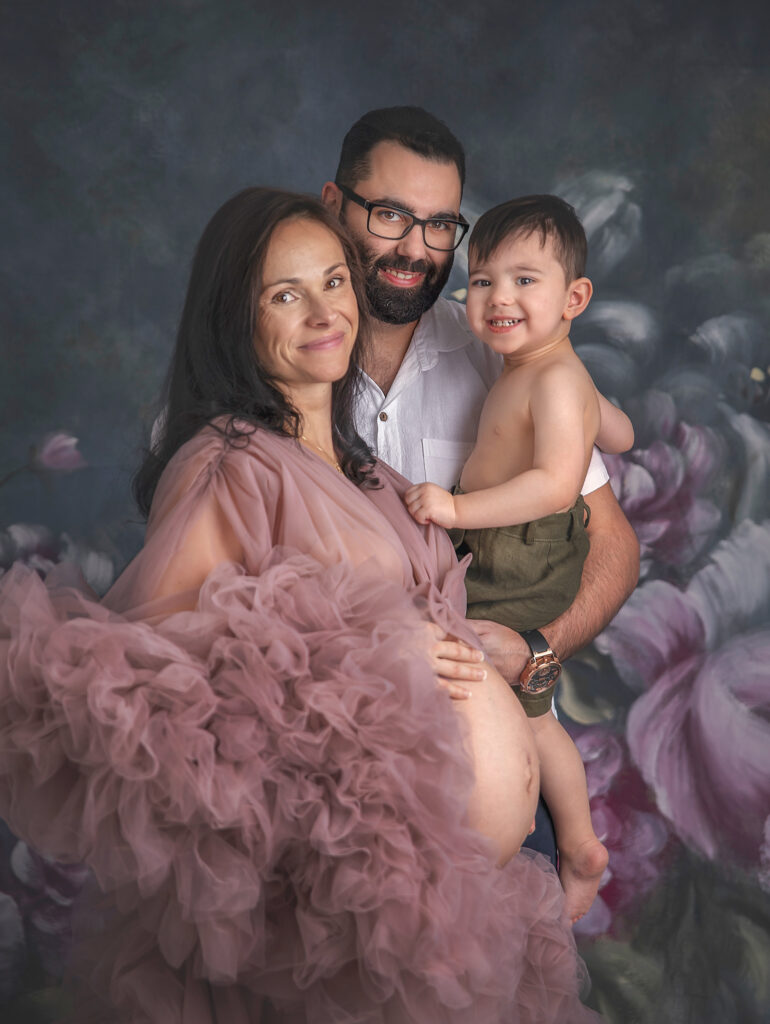 Family posing together during luxury maternity photography session in Ottawa.