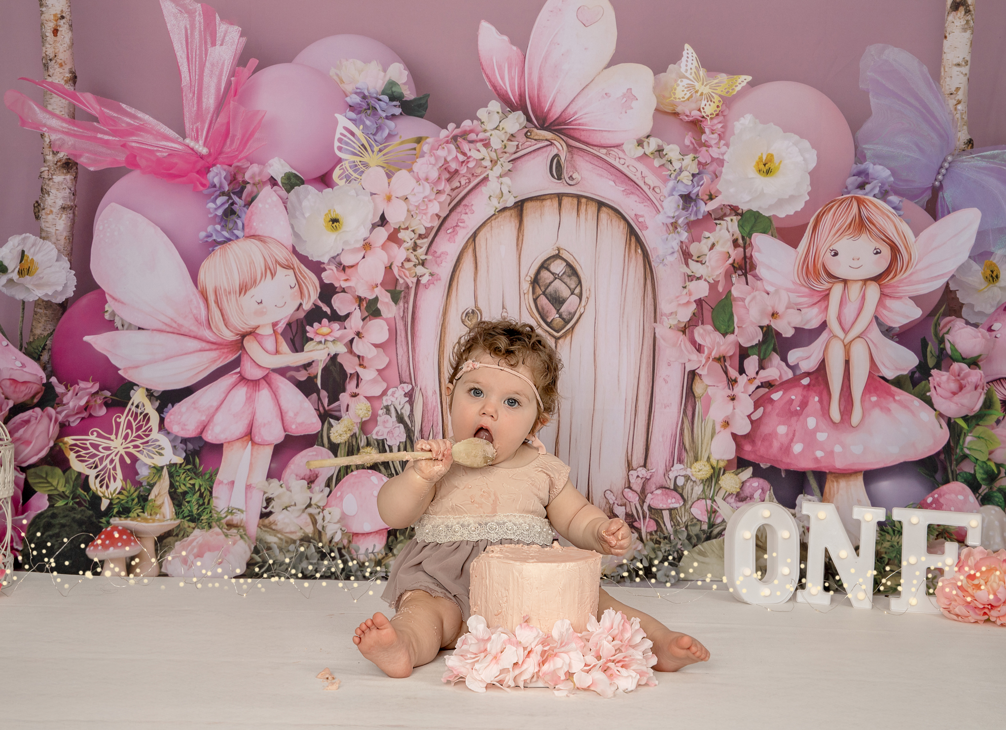 Baby eating cake in whimsical fairy cake smash backdrop Ottawa