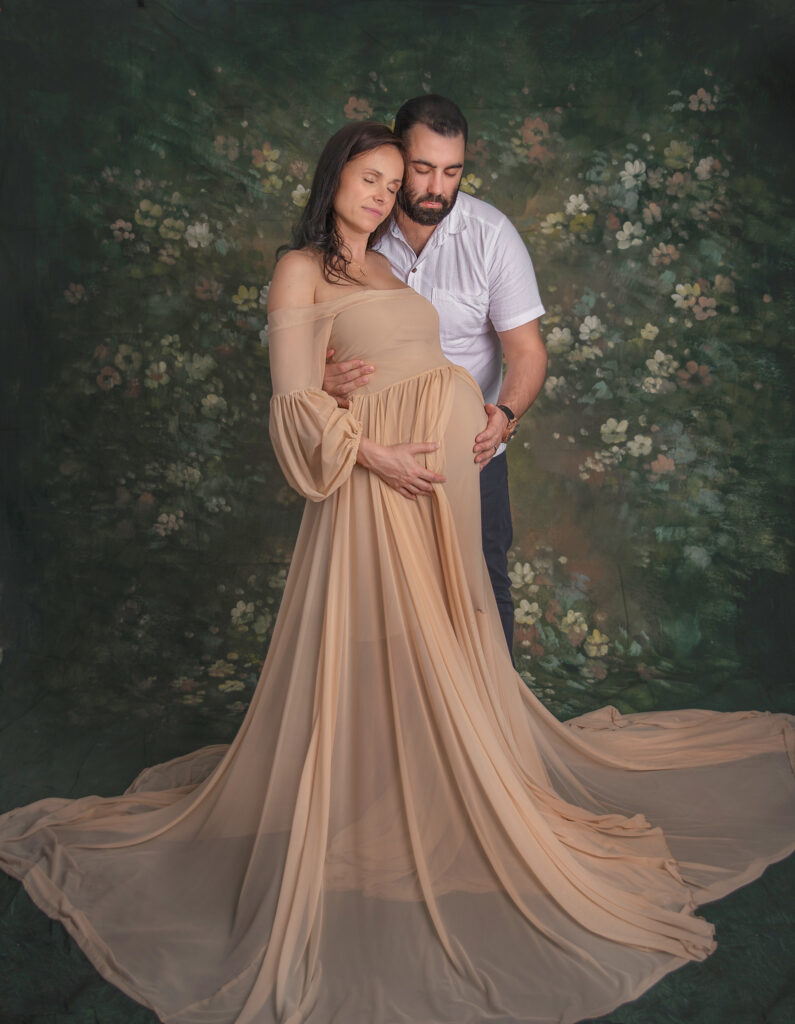 Partner embracing pregnant mother during maternity portrait session in Ottawa.