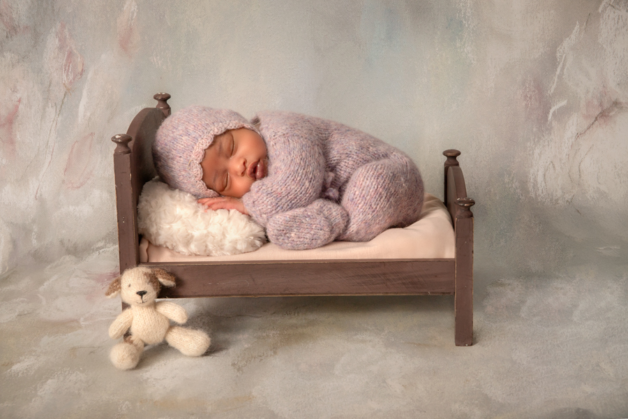sleeping newborn girl in lavender bed prop with subtle soft pink accents, Ottawa newborn photography.