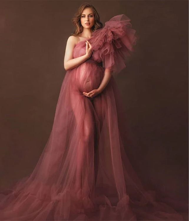 Pregnant woman wearing a pink maternity gown during an elegant studio maternity photoshoot in Ottawa