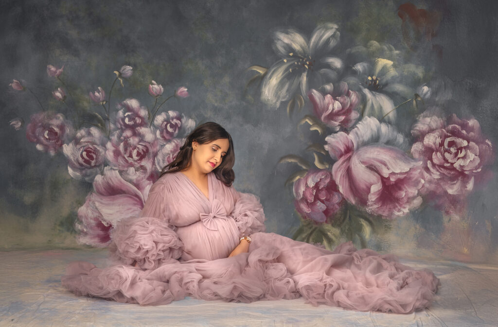 Expecting mom posing in a flowing maternity robe during an elegant studio maternity photoshoot in Ottawa