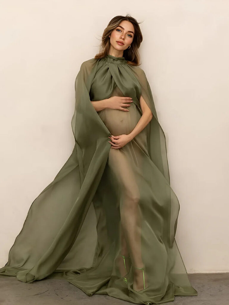 Expecting mother wrapped in olive green flowing fabric during an artistic maternity photoshoot in Ottawa studio